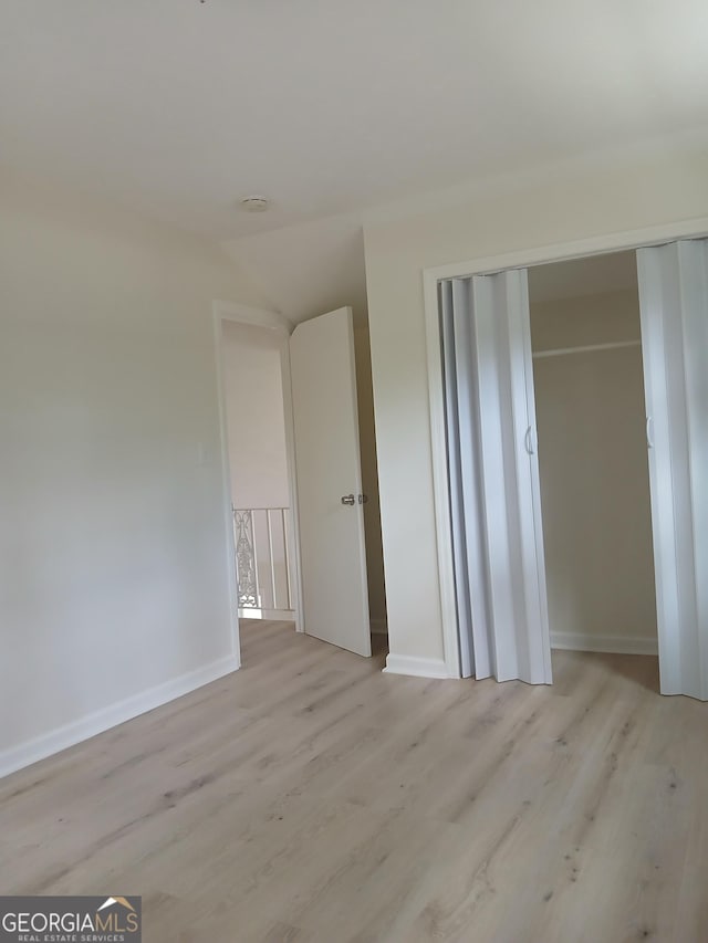 6985 Butner Rd, South Fulton, GA 30349 - unfurnished bedroom with wood finished floors and a closet