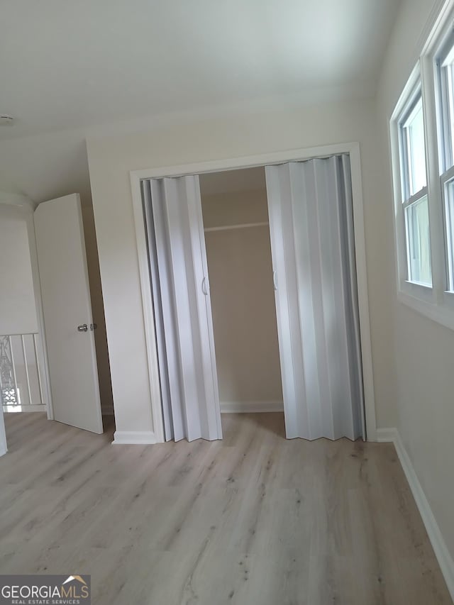 6985 Butner Rd, South Fulton, GA 30349 - unfurnished bedroom with light wood-style flooring and a closet