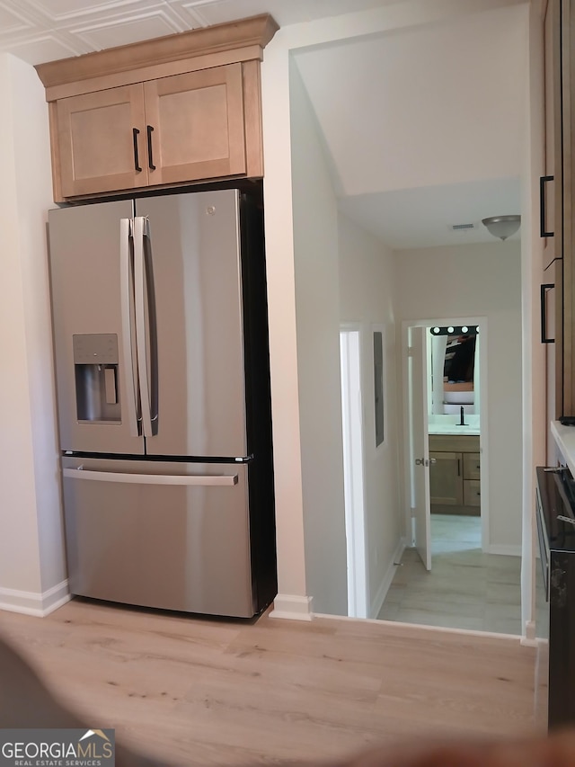 6985 Butner Rd, South Fulton, GA 30349 - kitchen featuring stainless steel refrigerator with ice dispenser and light wood-style floors