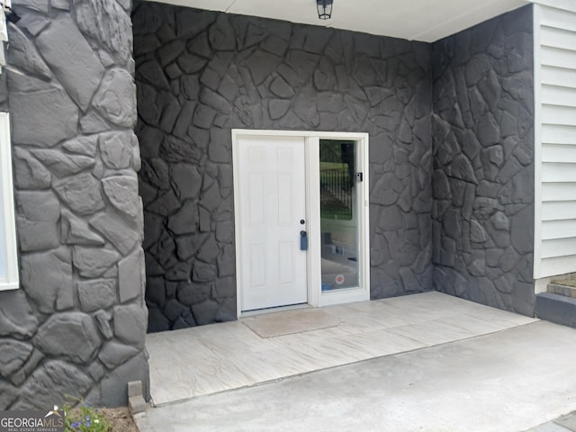 6985 Butner Rd, South Fulton, GA 30349 - doorway to property featuring stone siding
