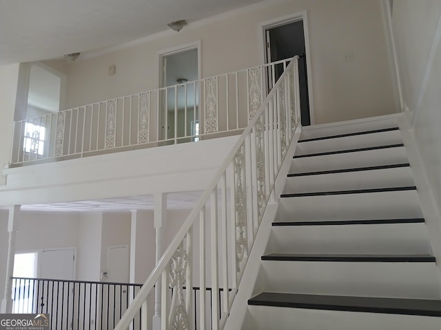 6985 Butner Rd, South Fulton, GA 30349 - staircase featuring a towering ceiling and crown molding