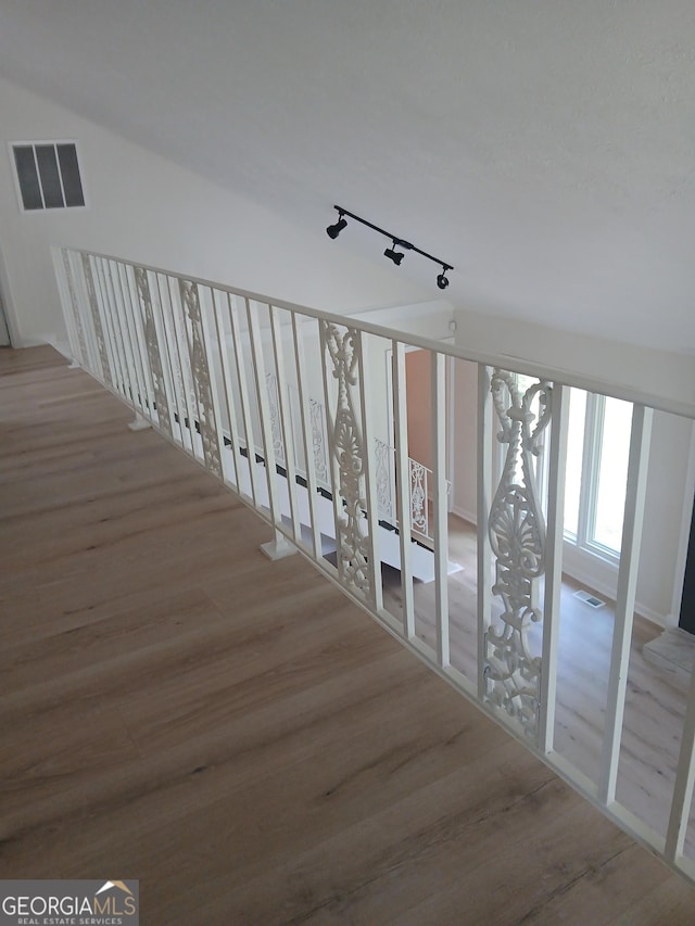 6985 Butner Rd, South Fulton, GA 30349 - corridor featuring wood finished floors and rail lighting