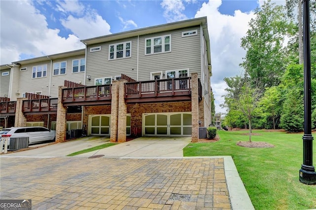 711 Topsail Ln, Alpharetta, GA 30005 - back of property featuring a garage, driveway, a yard, brick siding, and a deck