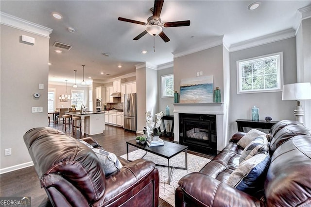 711 Topsail Ln, Alpharetta, GA 30005 - living room with a ceiling fan, dark wood-type flooring, recessed lighting, a glass covered fireplace, and crown molding