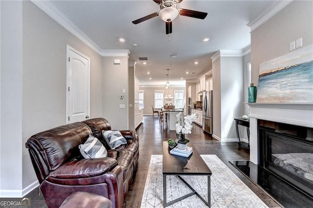 711 Topsail Ln, Alpharetta, GA 30005 - living area with crown molding, ceiling fan, a glass covered fireplace, recessed lighting, and dark wood-type flooring