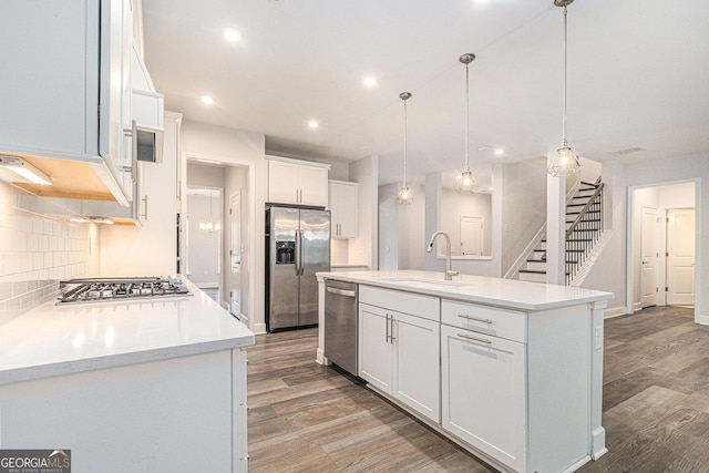129 Academy Ln, Canton, GA 30114 - kitchen featuring stainless steel appliances, tasteful backsplash, light wood-style floors, white cabinets, and recessed lighting