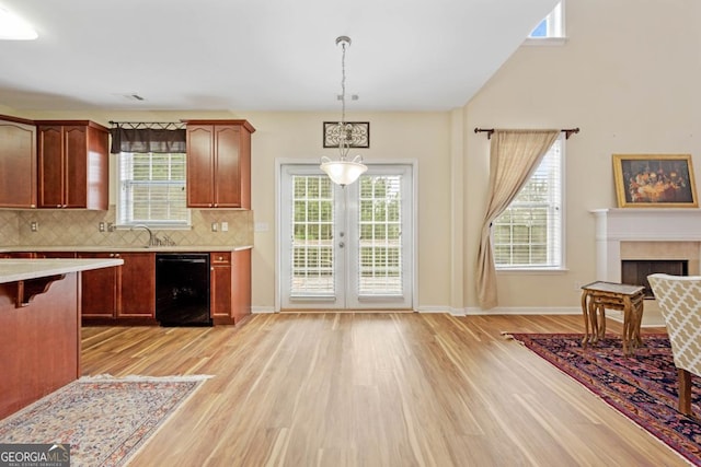 773 Van Briggle Path, Sugar Hill, GA 30518 - kitchen with dishwasher, light countertops, light wood-style flooring, and a breakfast bar area