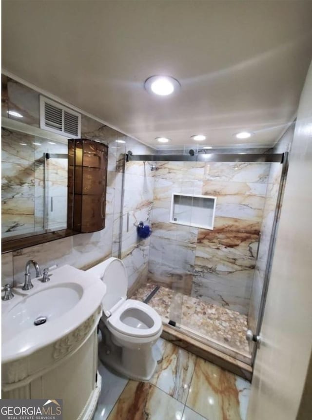 620 NE Peachtree St Unit 901, Atlanta, GA 30308 - bathroom featuring marble tiled flooring, a marble finish shower, vanity, and recessed lighting
