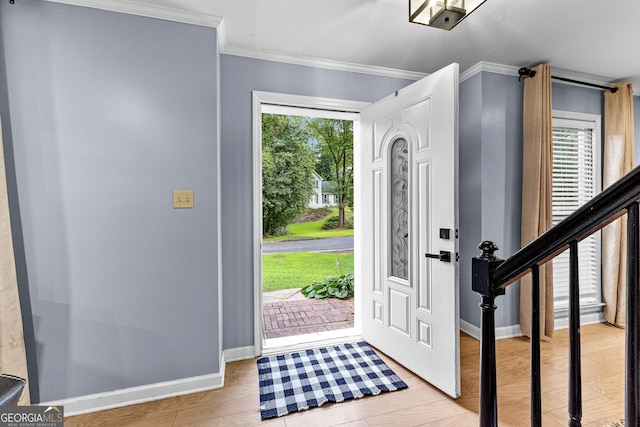 435 Hampton Grn, Peachtree City, GA 30269 - foyer entrance featuring ornamental molding, healthy amount of natural light, and light wood-type flooring