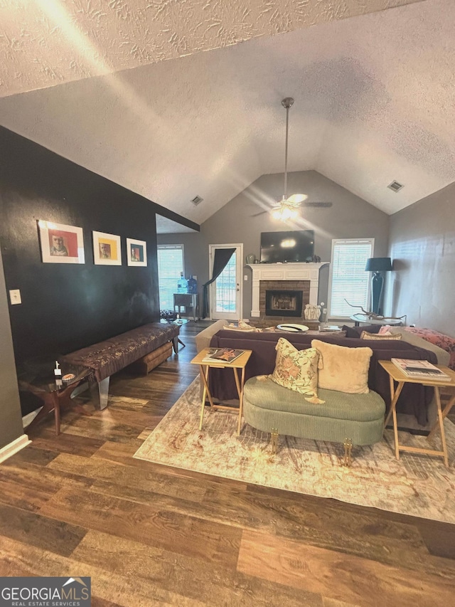 214 Sugar Hill Ct, Jackson, GA 30233 - living room featuring ceiling fan, wood finished floors, lofted ceiling, a fireplace, and a textured ceiling