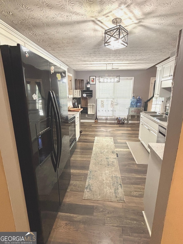 214 Sugar Hill Ct, Jackson, GA 30233 - kitchen featuring black refrigerator with ice dispenser, white cabinetry, dark wood-style flooring, light countertops, and a textured ceiling