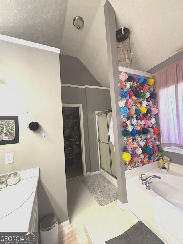 214 Sugar Hill Ct, Jackson, GA 30233 - bathroom featuring a stall shower, vaulted ceiling, a garden tub, vanity, and a walk in closet