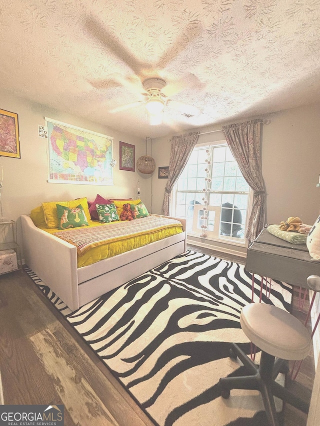 214 Sugar Hill Ct, Jackson, GA 30233 - bedroom with wood finished floors, a textured ceiling, and ceiling fan
