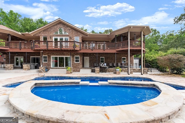 1572 Azalea Dr, Lawrenceville, GA 30043 - back of house with french doors, brick siding, a patio, and a pool with connected hot tub