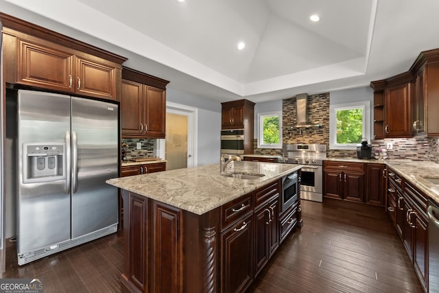 1572 Azalea Dr, Lawrenceville, GA 30043 - kitchen featuring appliances with stainless steel finishes, wall chimney range hood, light stone counters, tasteful backsplash, and dark wood-style floors