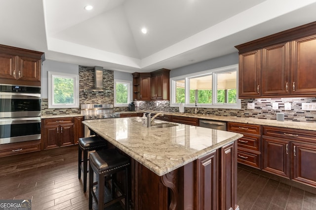 1572 Azalea Dr, Lawrenceville, GA 30043 - kitchen featuring wall chimney exhaust hood, stainless steel appliances, tasteful backsplash, light stone countertops, and dark wood-style floors