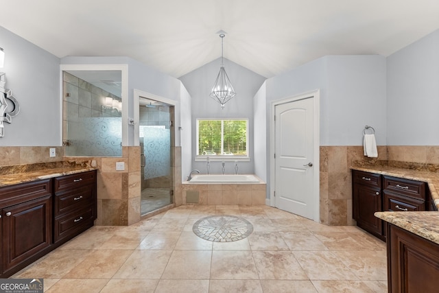1572 Azalea Dr, Lawrenceville, GA 30043 - bathroom featuring a chandelier, tile walls, a garden tub, a stall shower, and vanity