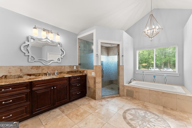 1572 Azalea Dr, Lawrenceville, GA 30043 - bathroom with vanity, a stall shower, a bath, tile patterned floors, and a chandelier