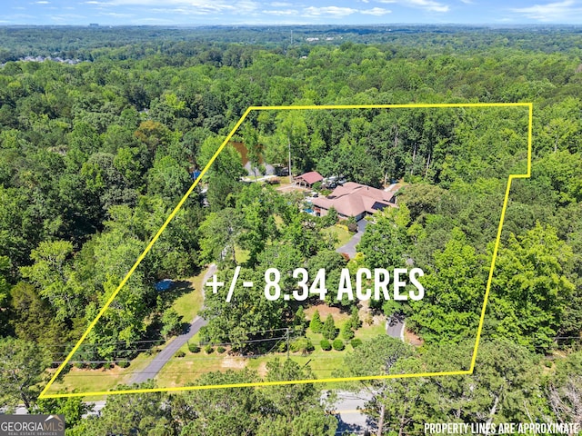 1572 Azalea Dr, Lawrenceville, GA 30043 - aerial view of property and surrounding area featuring a heavily wooded area and property parcel outlined