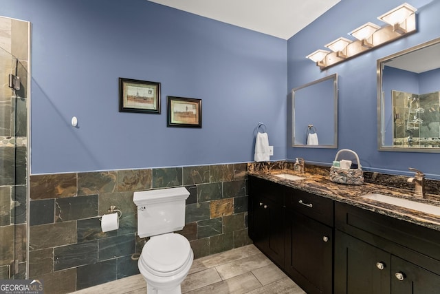 1572 Azalea Dr, Lawrenceville, GA 30043 - full bath featuring tile walls, double vanity, a wainscoted wall, and a tile shower