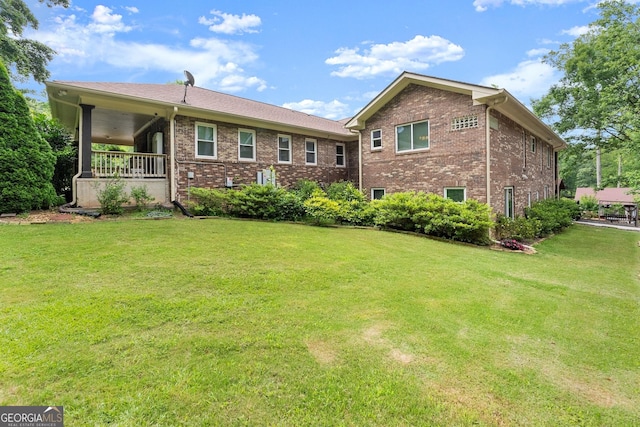 1572 Azalea Dr, Lawrenceville, GA 30043 - back of property featuring brick siding and a lawn