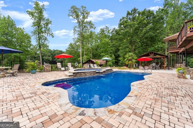 1572 Azalea Dr, Lawrenceville, GA 30043 - view of pool with a patio area, outdoor dining space, a pool with connected hot tub, a gazebo, and view of scattered trees