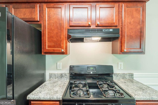 513 Shadow Valley Ct, Lithonia, GA 30058 - kitchen featuring black appliances, under cabinet range hood, and brown cabinetry