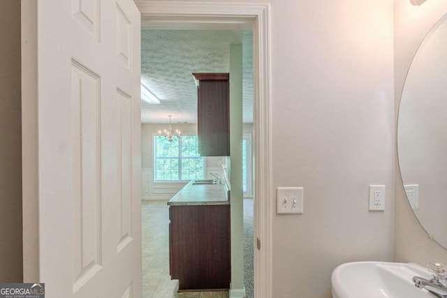 513 Shadow Valley Ct, Lithonia, GA 30058 - bathroom featuring a sink and a chandelier