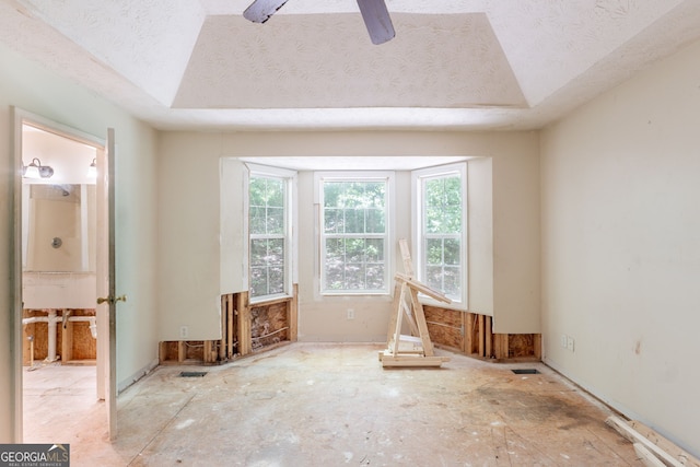 3930 Pine Tree Ln, Gainesville, GA 30501 - empty room with healthy amount of natural light, a ceiling fan, a tray ceiling, and a textured ceiling