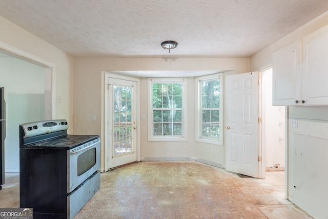 3930 Pine Tree Ln, Gainesville, GA 30501 - kitchen featuring stainless steel range with electric stovetop, white cabinets, and a textured ceiling