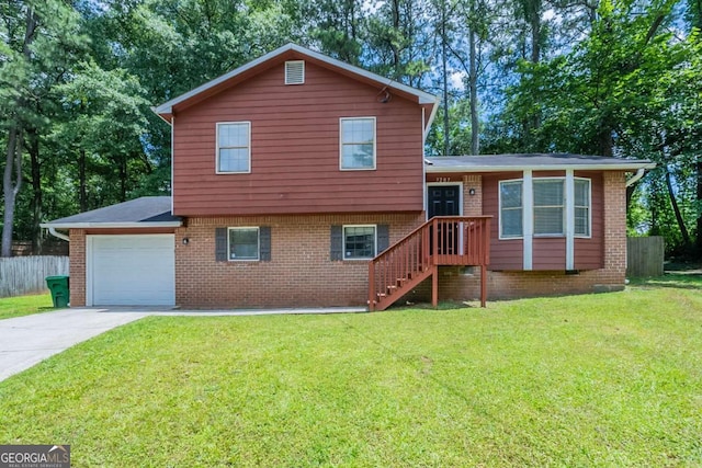 5207 Shawn Ln, Stone Mountain, GA 30088 - split level home featuring an attached garage, concrete driveway, and brick siding
