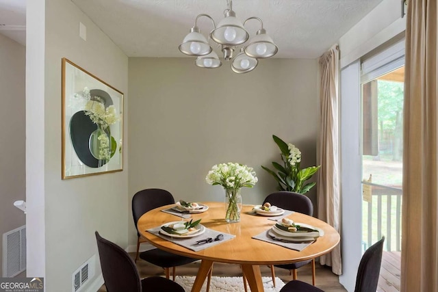 5207 Shawn Ln, Stone Mountain, GA 30088 - dining room featuring a chandelier and wood finished floors