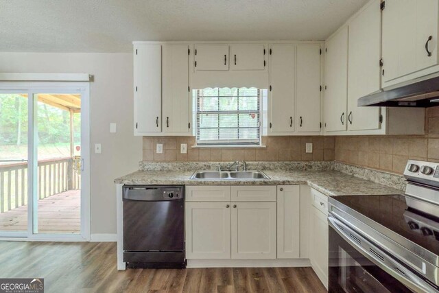 5207 Shawn Ln, Stone Mountain, GA 30088 - kitchen featuring electric range, black dishwasher, under cabinet range hood, dark wood-style flooring, and backsplash