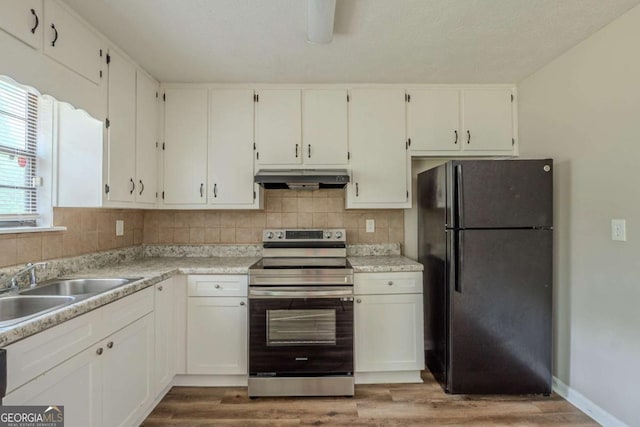 5207 Shawn Ln, Stone Mountain, GA 30088 - kitchen featuring freestanding refrigerator, electric range, under cabinet range hood, and wood finished floors