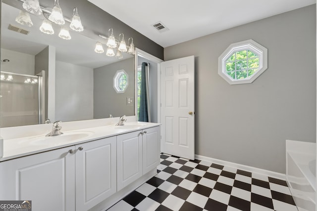 13495 Spring View Dr, Alpharetta, GA 30004 - bathroom with tile patterned floors, healthy amount of natural light, double vanity, and a garden tub