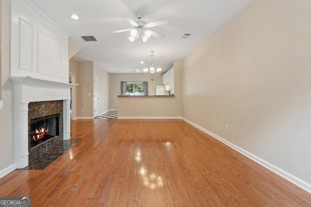 13495 Spring View Dr, Alpharetta, GA 30004 - unfurnished living room featuring ceiling fan, light wood-style floors, a chandelier, a premium fireplace, and recessed lighting