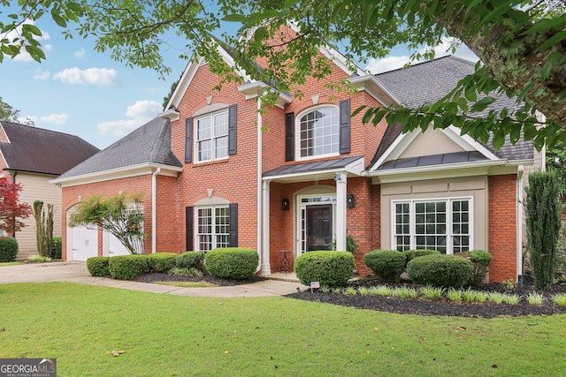 2009 Mclain Rd NW, Acworth, GA 30101 - traditional-style house featuring brick siding, a garage, and a front lawn