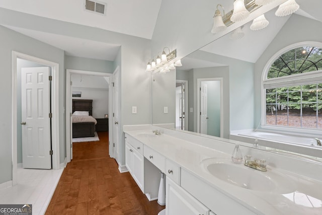 2009 Mclain Rd NW, Acworth, GA 30101 - ensuite bathroom featuring double vanity, a bath, high vaulted ceiling, and wood finished floors