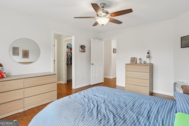 2009 Mclain Rd NW, Acworth, GA 30101 - bedroom with dark wood-type flooring, a spacious closet, and a ceiling fan