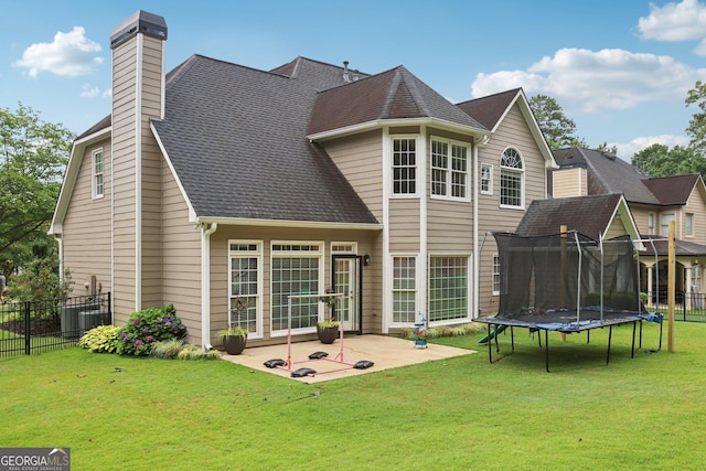 2009 Mclain Rd NW, Acworth, GA 30101 - back of house with a patio area, a trampoline, a chimney, and roof with shingles