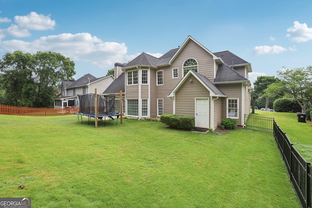 2009 Mclain Rd NW, Acworth, GA 30101 - back of house featuring a trampoline, a fenced backyard, and a shingled roof