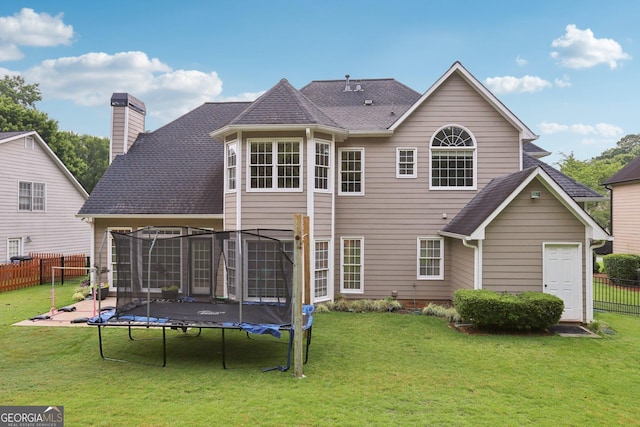 2009 Mclain Rd NW, Acworth, GA 30101 - rear view of house with a trampoline, a chimney, and a shingled roof