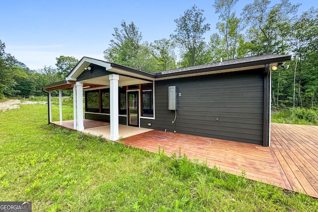 735 Firetower Rd, Thomaston, GA 30286 - back of property featuring a wooden deck, a lawn, and a patio