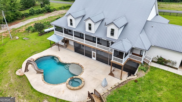 735 Firetower Rd, Thomaston, GA 30286 - rear view of property featuring a patio, a metal roof, a pool with connected hot tub, a sunroom, and a balcony