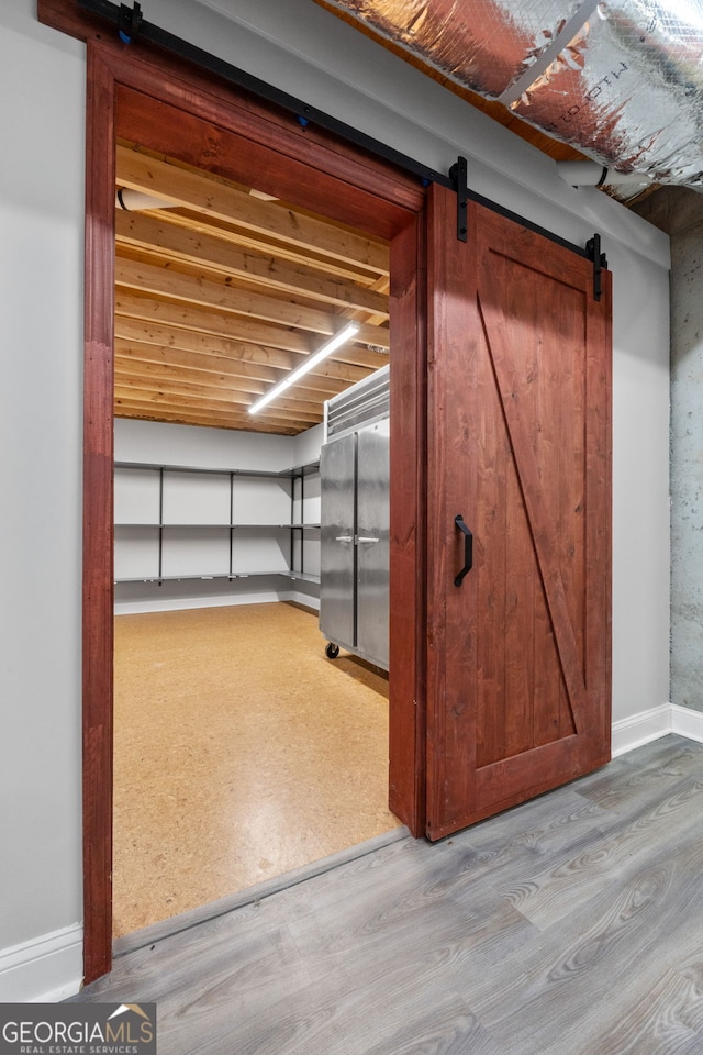 735 Firetower Rd, Thomaston, GA 30286 - below grade area featuring a barn door and wood finished floors