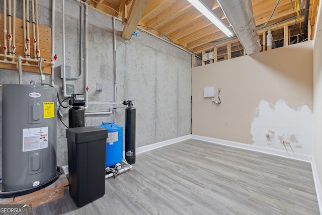 735 Firetower Rd, Thomaston, GA 30286 - unfinished below grade area with water heater, wood finished floors, and a water pressure tank