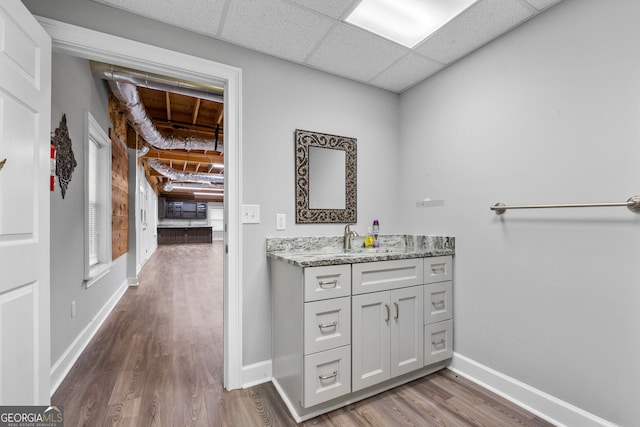 735 Firetower Rd, Thomaston, GA 30286 - bathroom with wood finished floors, vanity, and a paneled ceiling