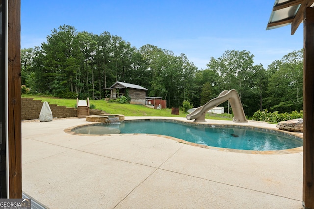 735 Firetower Rd, Thomaston, GA 30286 - view of pool featuring a patio area, a water slide, a lawn, and an outdoor structure