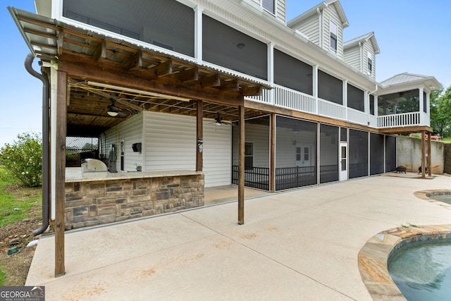 735 Firetower Rd, Thomaston, GA 30286 - back of house featuring a sunroom, a patio, an outdoor pool, and ceiling fan