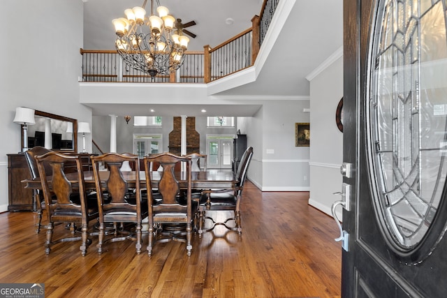 735 Firetower Rd, Thomaston, GA 30286 - dining space with wood finished floors, crown molding, a chandelier, and a towering ceiling